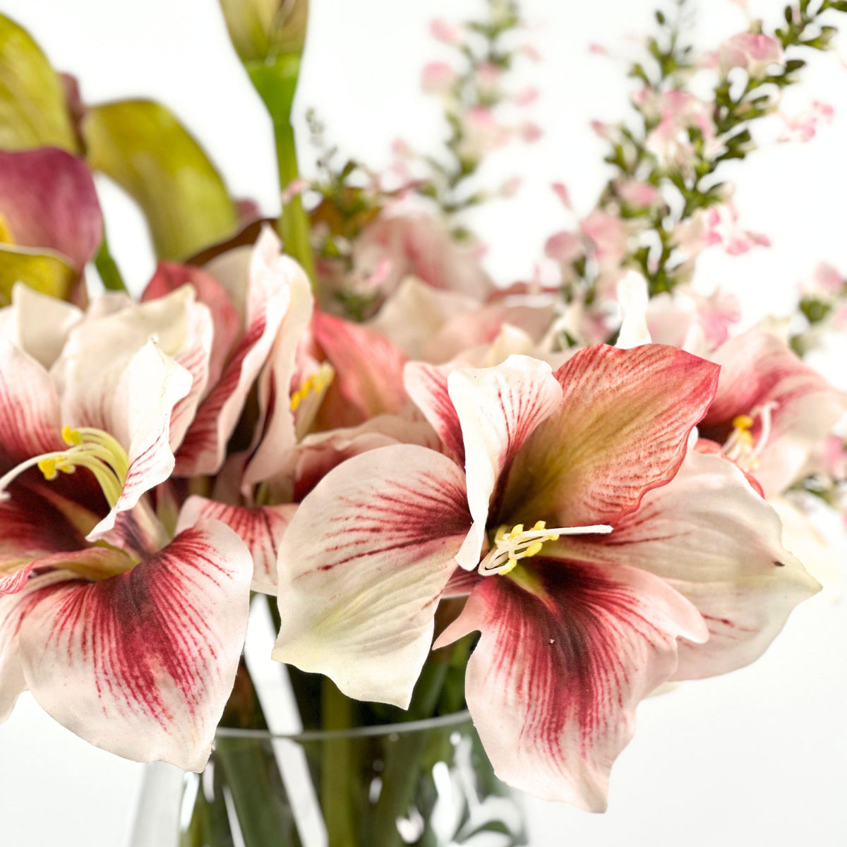 Amaryllis Calla Lily Oncidium Pink Mix Silk Flower Arrangement in Glass Vase. Close up view. Plant Couture.