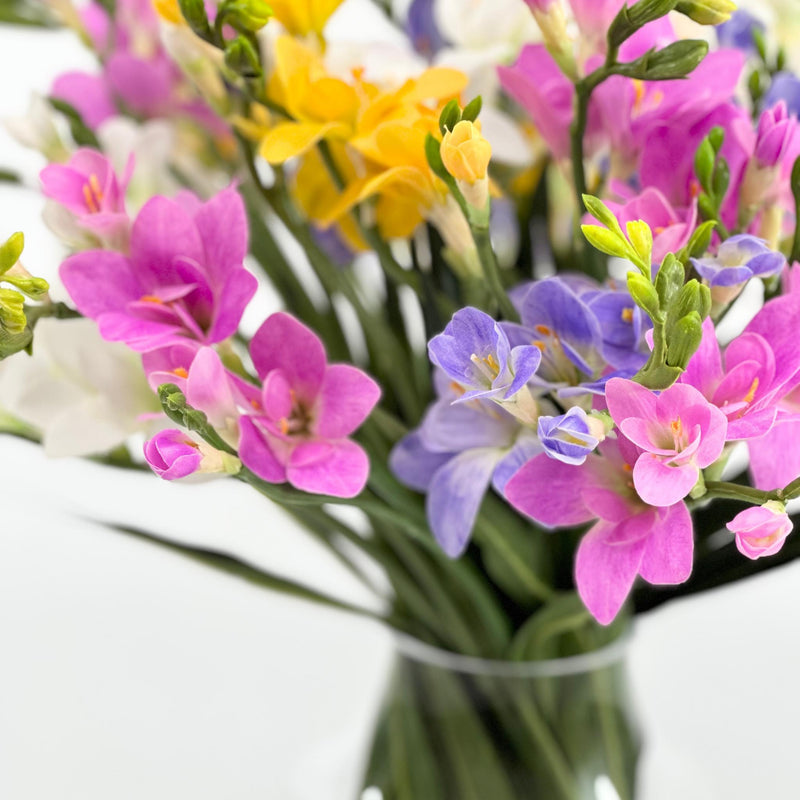 Freezia Mix Silk Flower Arrangement in Glass Vase. Top close up view. Arrangements available from www.plantcouture.co.za