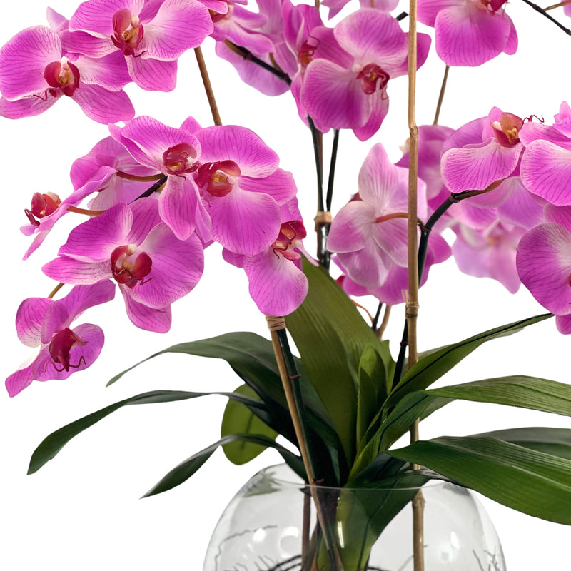 Close-up of flower of Faux purple Phalaenopsis Orchid arrangement 