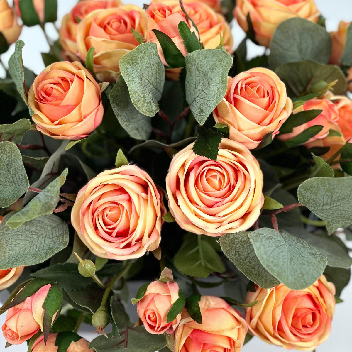 Roses Peach Silk Flower Arrangement in Black Ceramic Planter. Full top close up view. Available from www.plantcouture.co.za